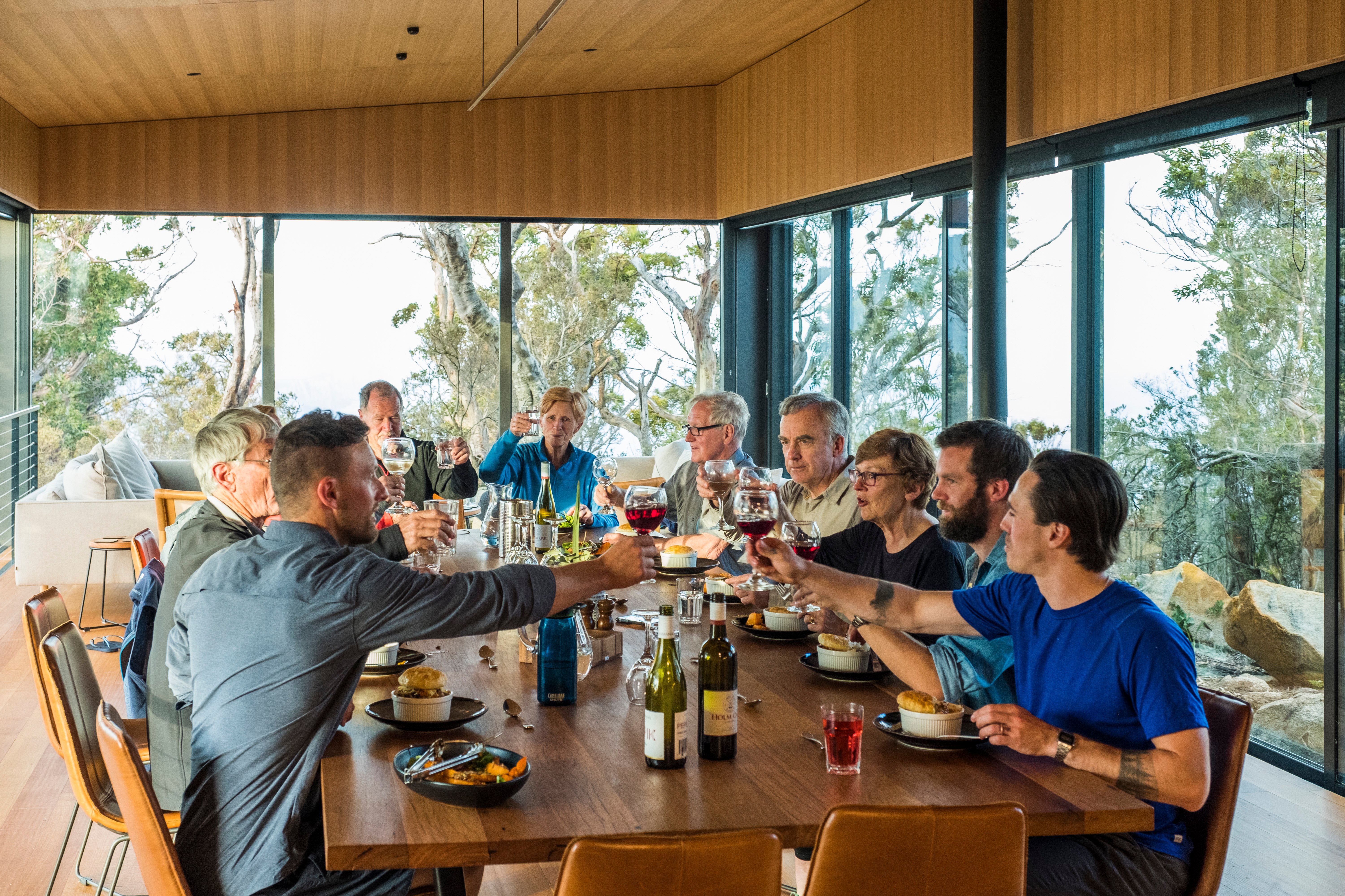 A group of people eating lunch together around a large dining table